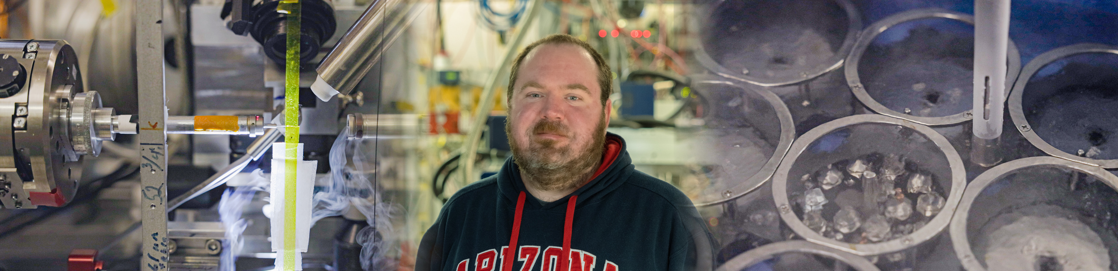 portrait of Aaron Finke with beamline components