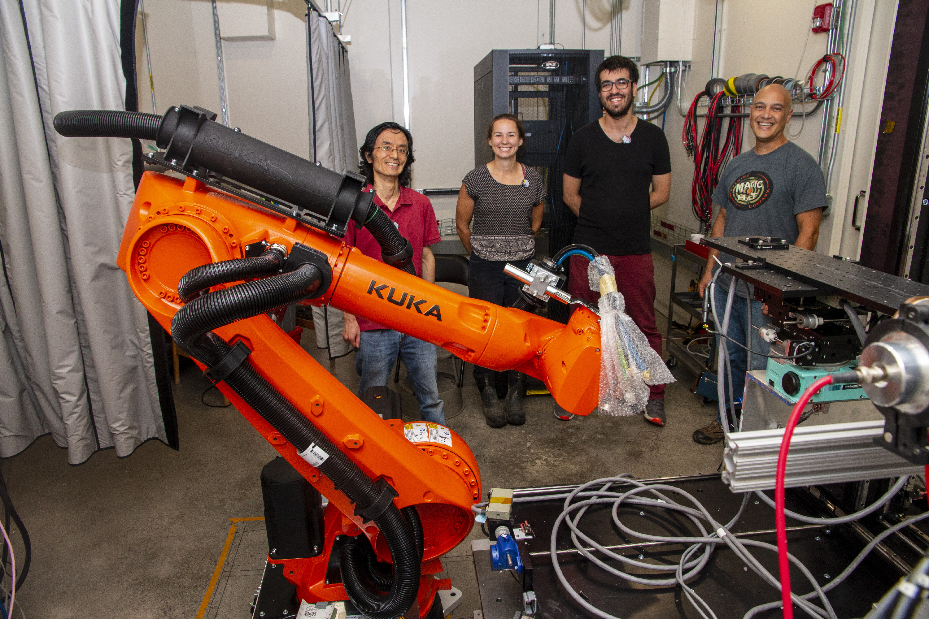 image of people standing behind a Kuka robot