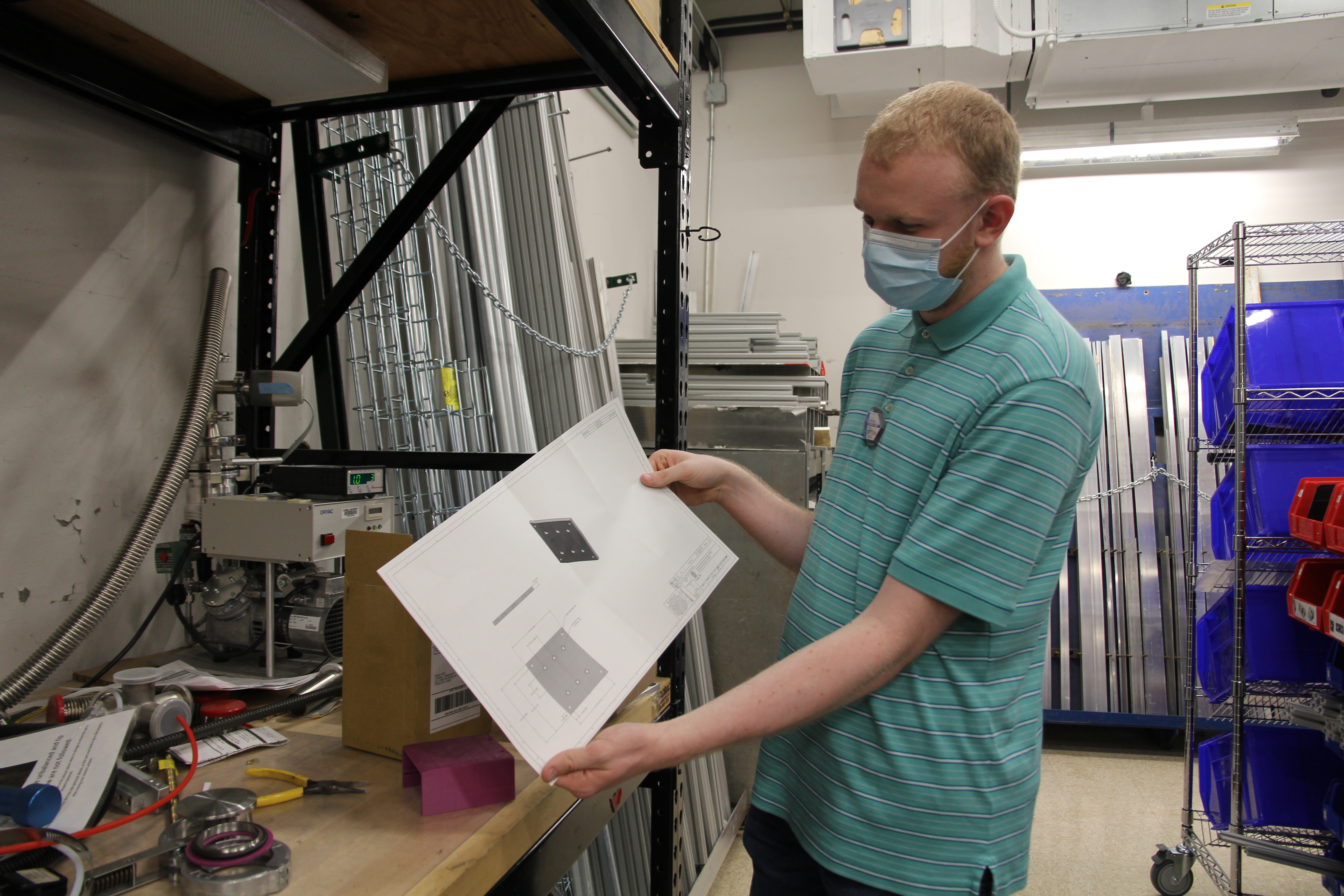 image of a person holding a printed out schematic