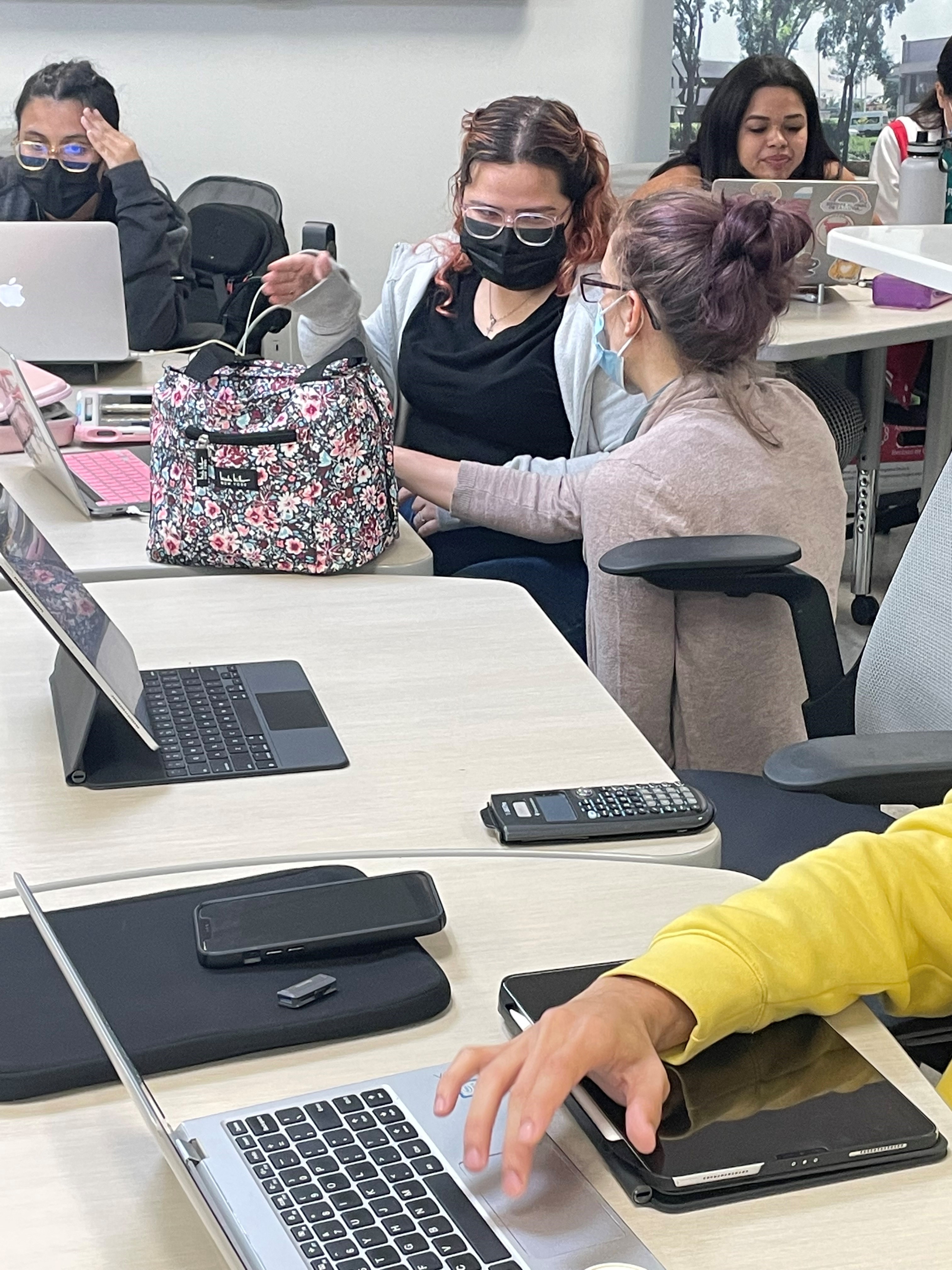 image of students collaborating on laptops