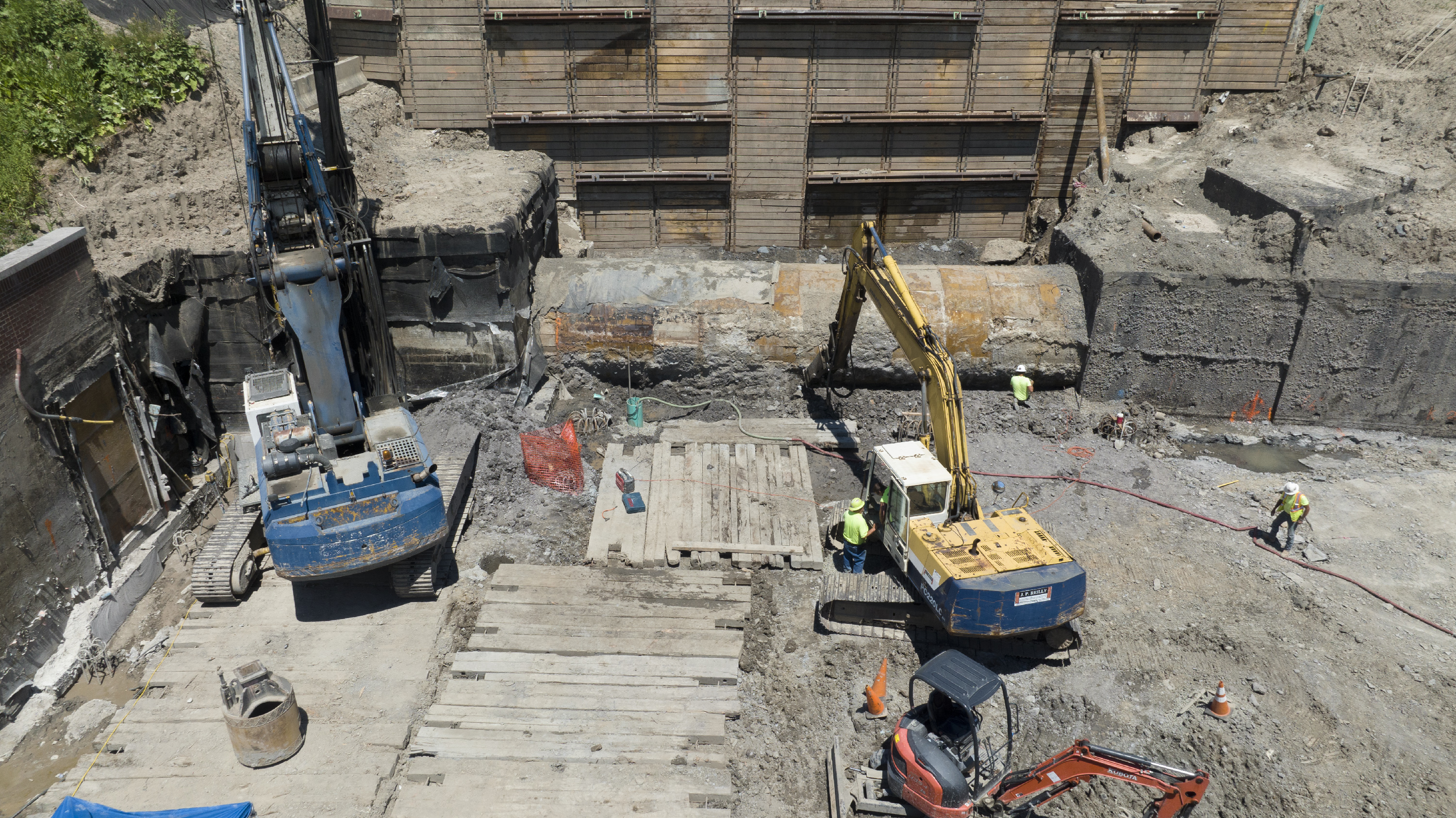 Image of a construction site with equipment unearthing a concrete tunnel