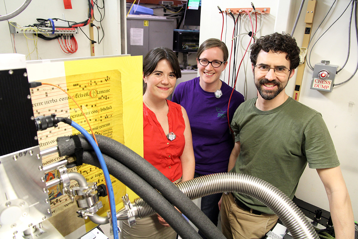 Ruth Mullett, Louisa Smieska, and Arthur Woll with a manuscript fragment and Maia detector in the A2 beamline