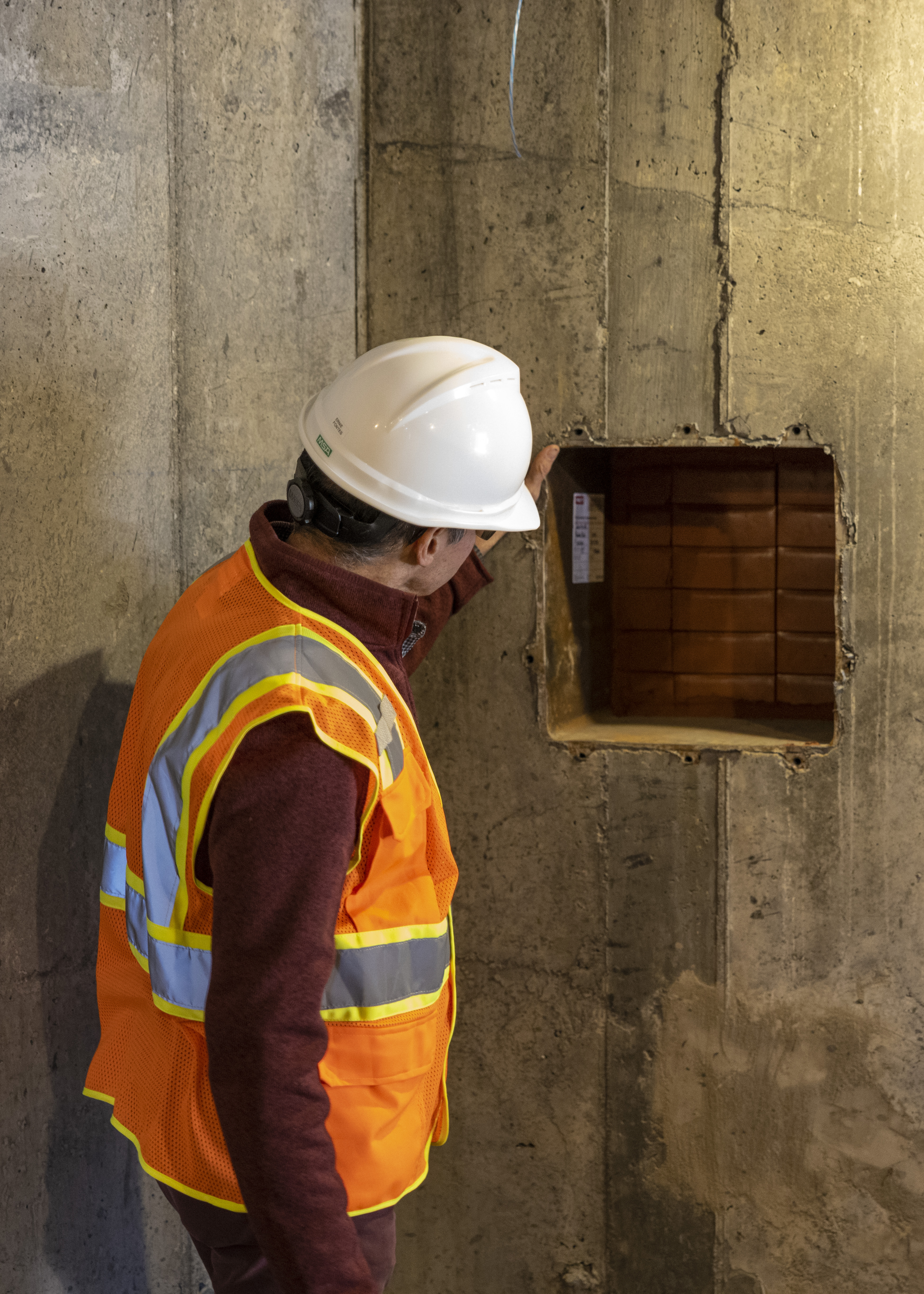 Image of a person in front of a concrete wall