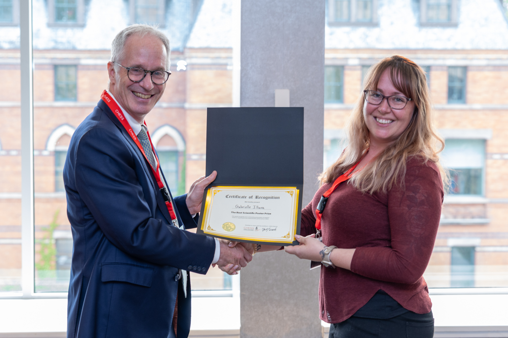 Image of a man presenting a certificate to a woman