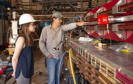 Jim Shanks and Grace King inspect the magnets that are going into the upgraded portion of CESR.