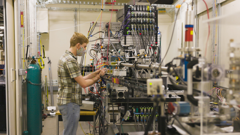Chris Pollock adjusting an instrument at the PIPOXS beamline