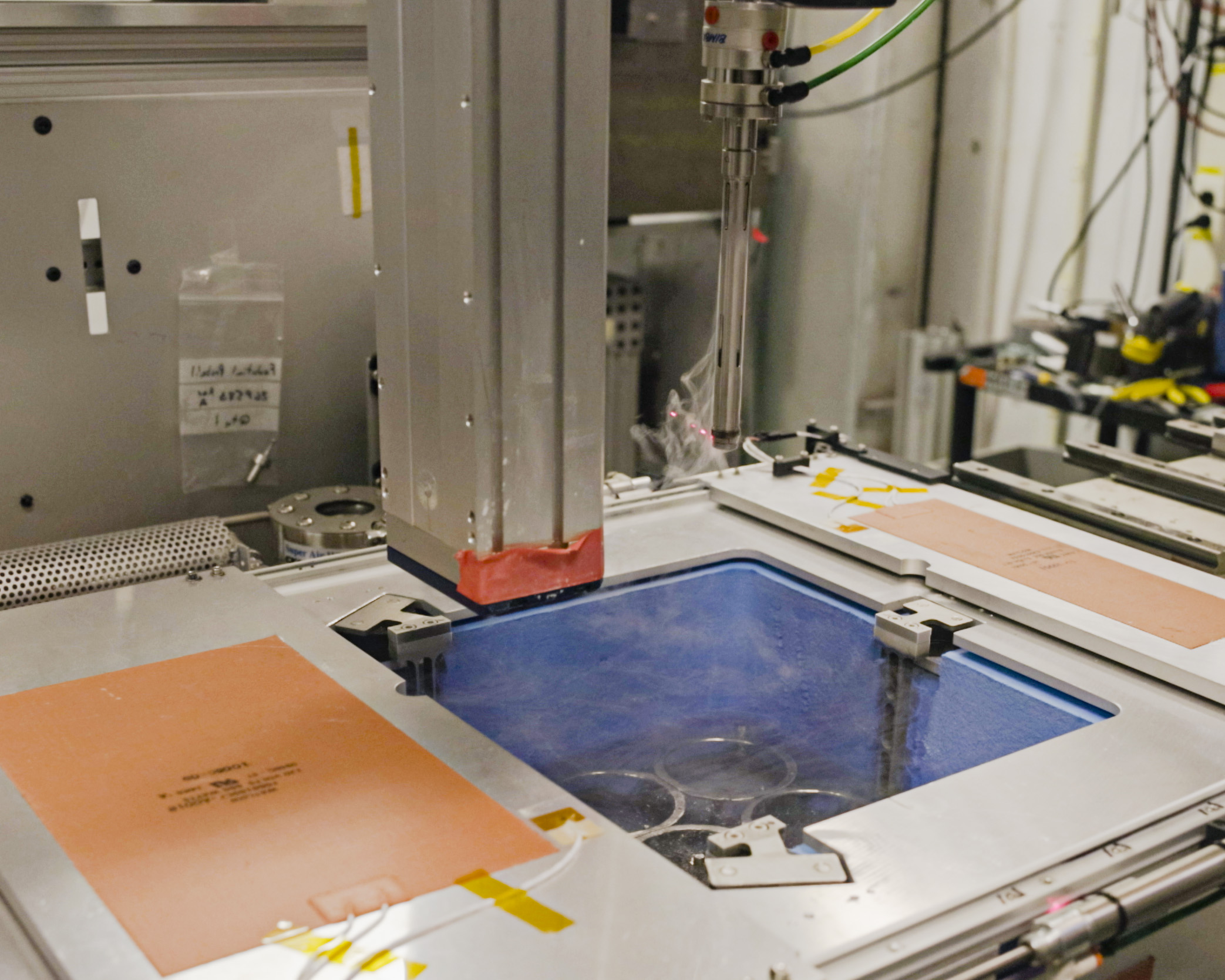 image shows a robot extracting samples from liquid nitrogen