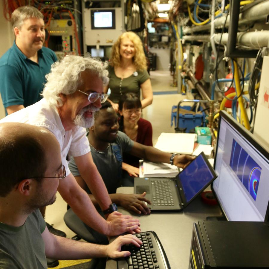 Showing workshop participants looking at a computer screen.