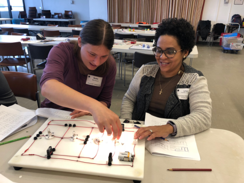 Cornell graduate student Robin Bjorkquist works with Lymari Fuentes-Claudio  on the Foutan Boards electric circuit investigation during the October 13 workshop.