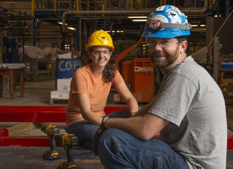 Stock photo of people operating a machine