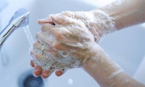 Woman washing hands at CHESS