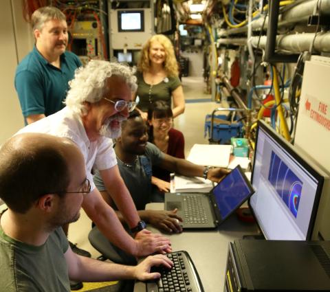 Showing workshop participants looking at a computer screen.