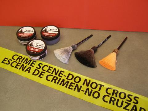A series of brushes and powders used for fingerprinting