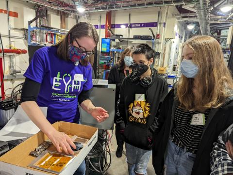 image of a scientist showing students research samples