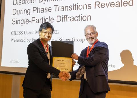 image of two people shaking hands and holding a certificate