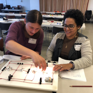 Cornell graduate student Robin Bjorkquist works with Lymari Fuentes-Claudio on the Foutan Boards electric circuit investigation during the October 13 workshop.