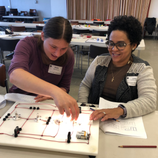 Cornell graduate student Robin Bjorkquist works with Lymari Fuentes-Claudio  on the Foutan Boards electric circuit investigation during the October 13 workshop.