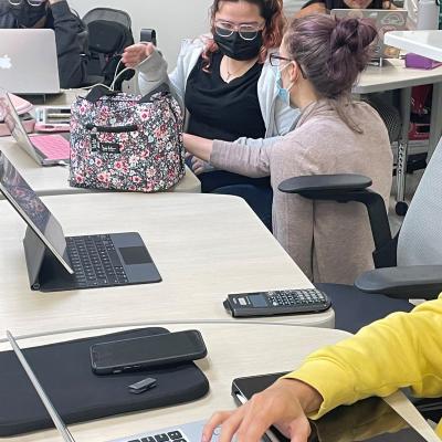 image of students collaborating on laptops