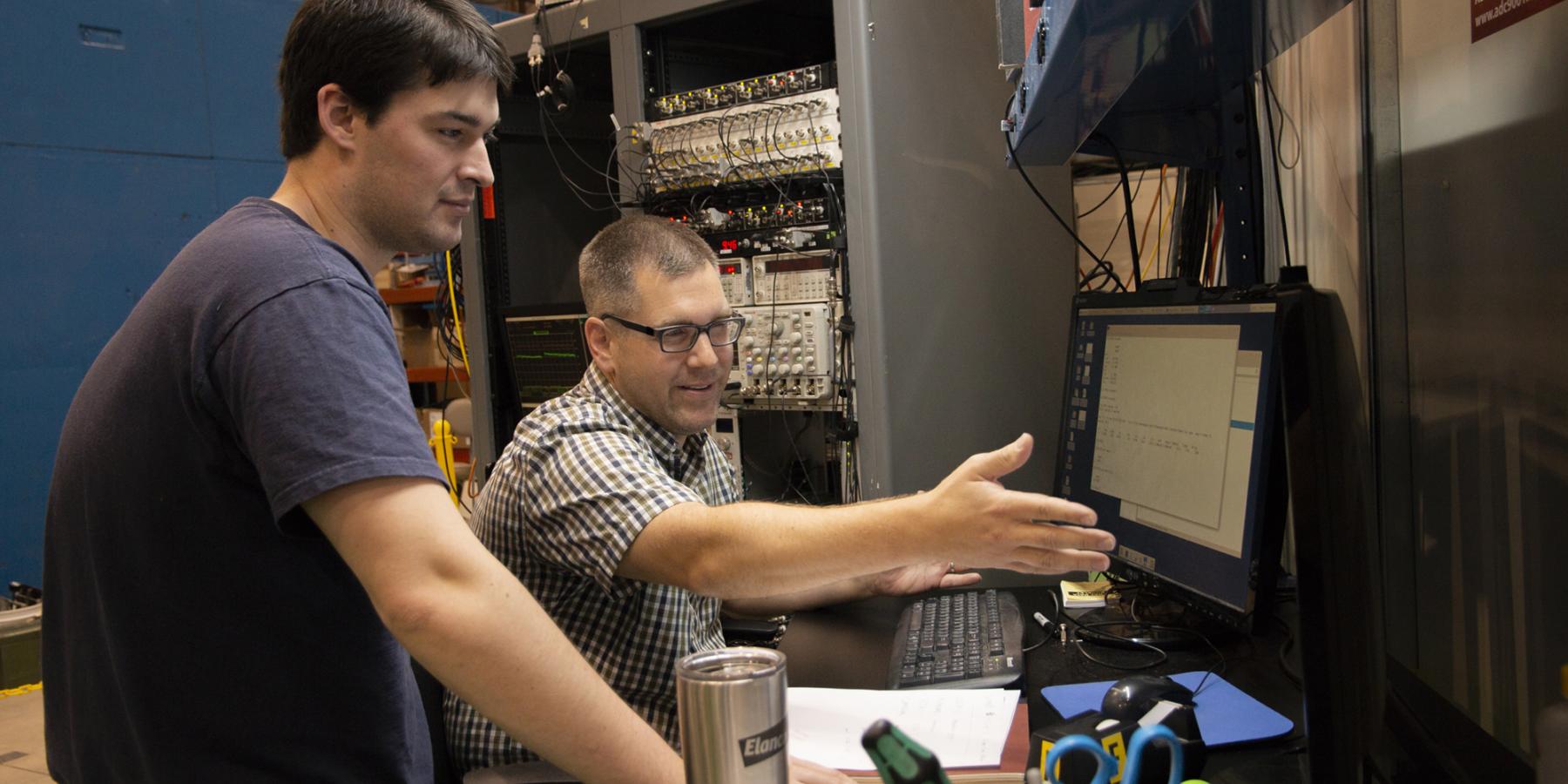 Justin Mach, right, from Caterpillar works with CHESS Graduate Student Chris Budrow during Justin's latest beam time. 
